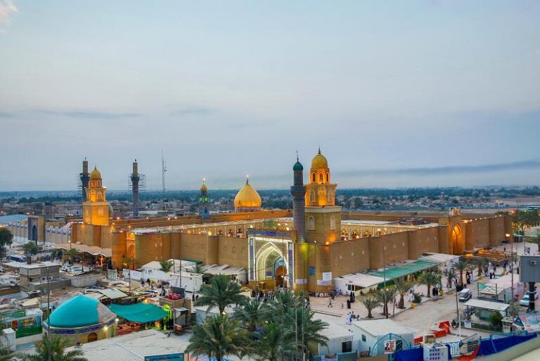 A panoramic view of the Imam Ali al-Hadi and Imam Hasan al-Askari Shrine complex in Samarra, Iraq, at dusk.